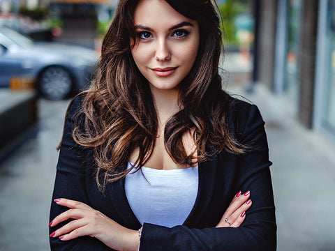 Confident woman alone on a sidewalk. 