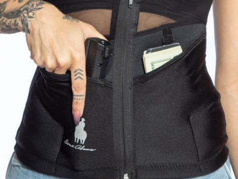 Concealed carry tank on a woman who is grabbing her gun. 