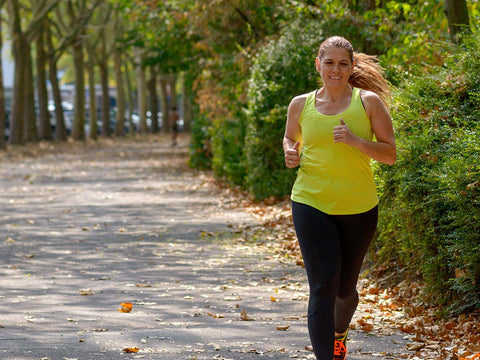 Woman running through the park. 