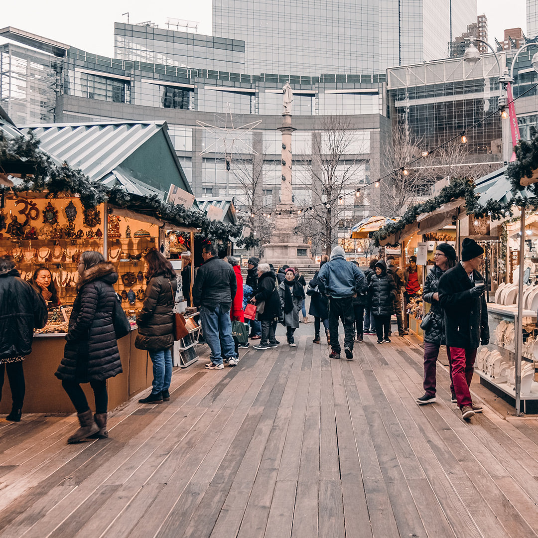 image of people Holiday shopping in the city in an outdoor market.