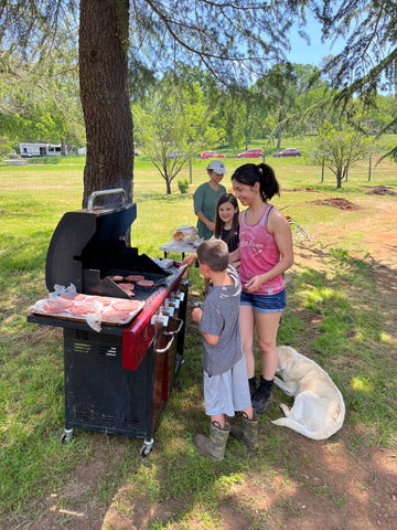 Ali Zeiter cooks hamburger patties from Family Friendly Farms with assistance from little helpers at Our Lady's Ranch in Grass Valley, CA.
