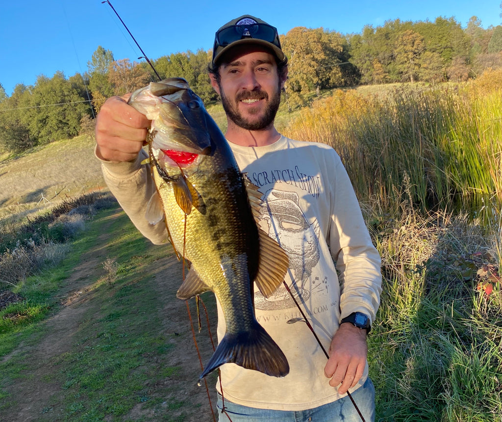 Fisherman Joe Conn holding up a large Big Mouth Bass. Family Friendly Farms sells sustainable grass-fed beef, pasture-raised pork, meadow-grass lamb, and free-range chicken.