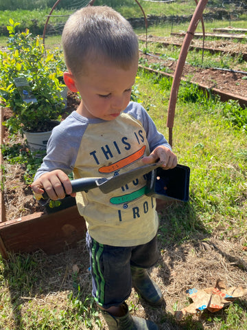 Family Friendly Farms at Our Lady's Ranch in Grass Valley, CA - little boy planting the summer garden.