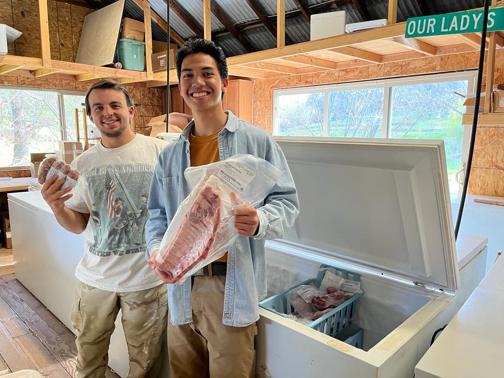 Isaiah and Stevenson at "The Shop" on Our Lady's Ranch. Family Friendly Farms sells sustainable grass-fed beef, pasture-raised pork, meadow-grass lamb, and free-range chicken.