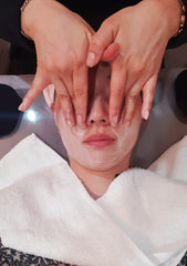 Therapist cleansing the skin to remove dirt and impurities
