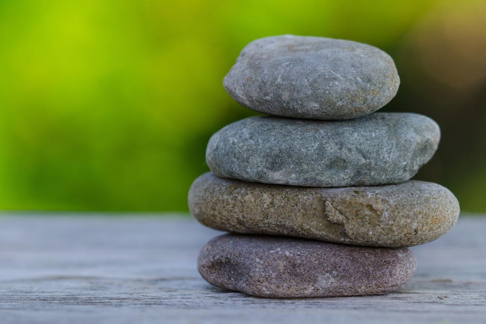 Rocks stacked on top of one another in a reaching zen exercise