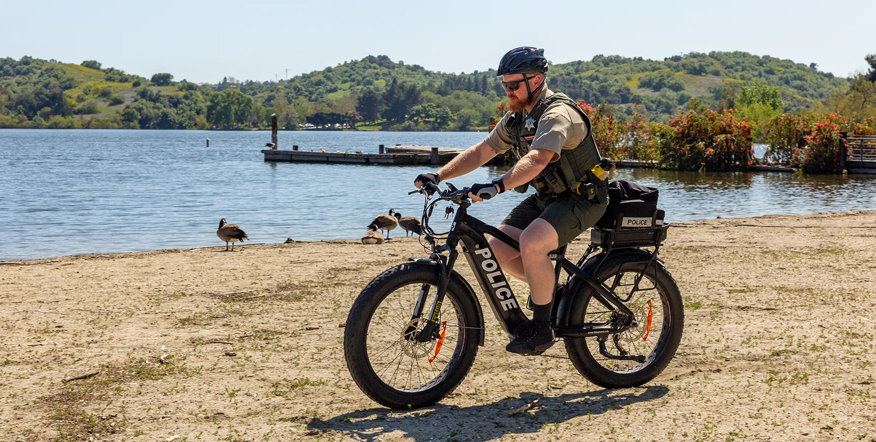 An officer riding through sand on the ATR 528 Police eBike