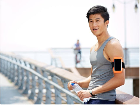 Man Holding A Water Bottle And Taking A Rest After Jogging