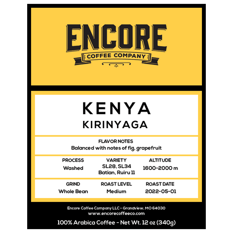 The image is a product label for Kenya Estate Peaberry coffee. The top of the label features a yellow banner with the Encore logo. The bottom half of the label contains information about the coffee, including its name, "Kenya Estate Peaberry," and additional text describing its flavor profile and origin. 