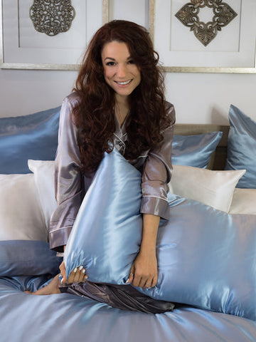 Woman holds Blue Silk Pillowcase