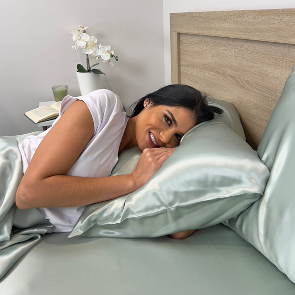 Model Sleeping on sage silk sheets and pillowcase