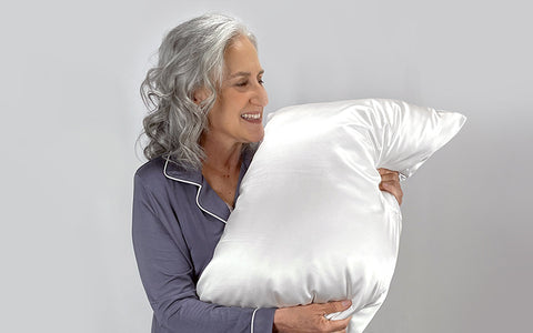 Older Woman Holds Silk pillowcase