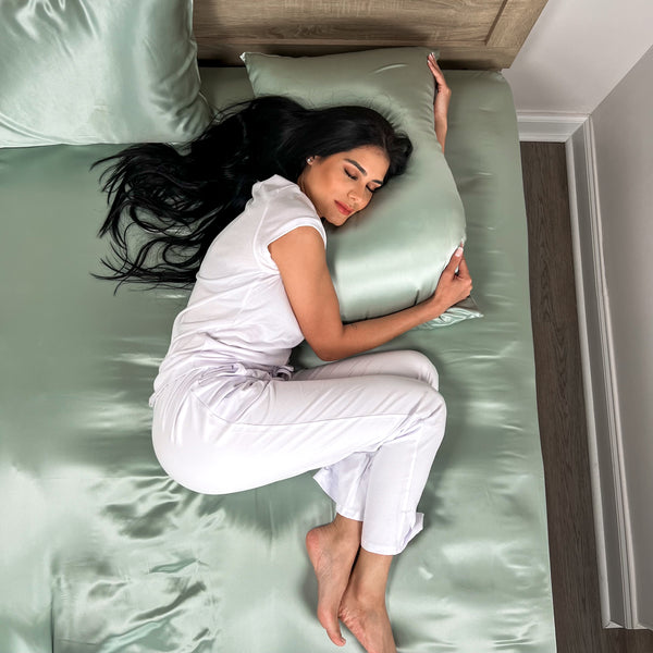 Model sleeping on silk sheets