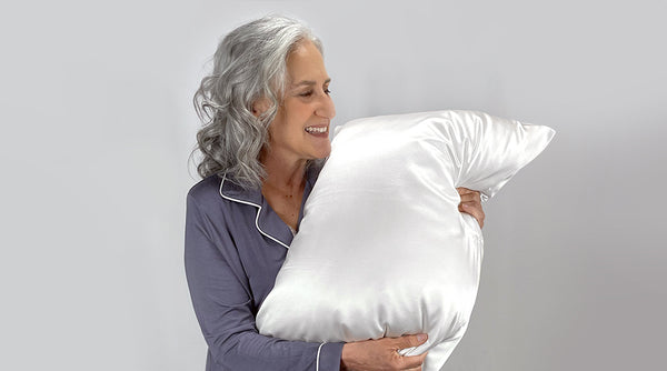 Older Model Holds Silk Pillowcase