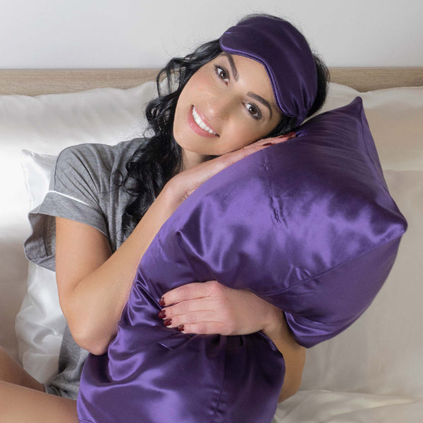 Woman hugs plum silk pillowcase