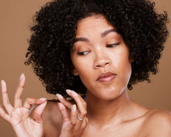 Woman Examine's a damaged curl