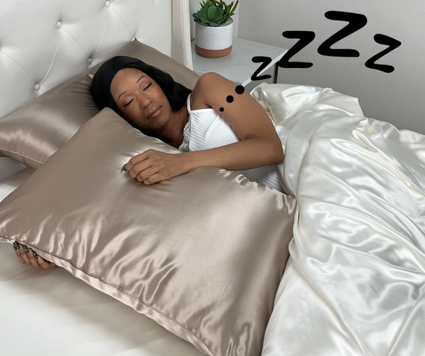 Model sleeping on taupe silk pillowcase