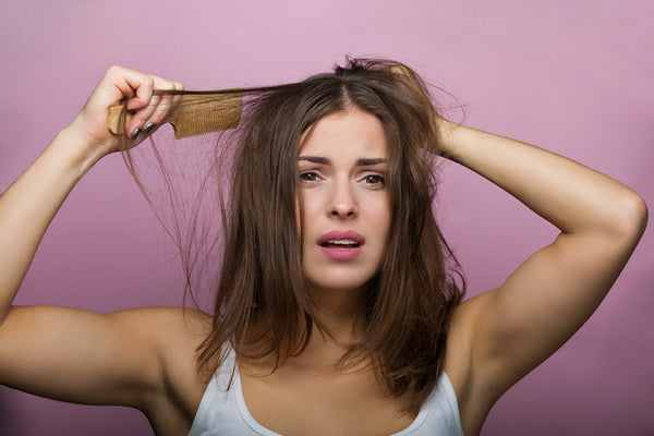 Woman Pulls At Her Damaged Hair