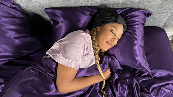 Model sleeps in silk plum bedding