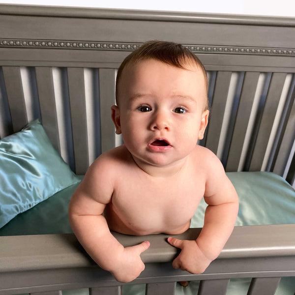 Baby stands up in crib