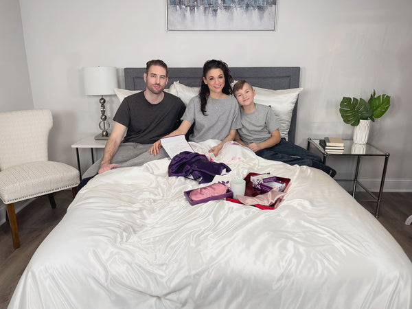 Mom, Dad and Son Sitting in Bed