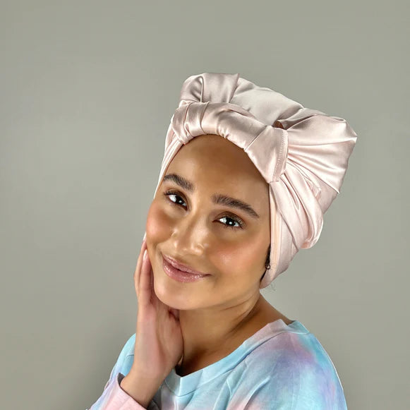 Model wears pink head scarf