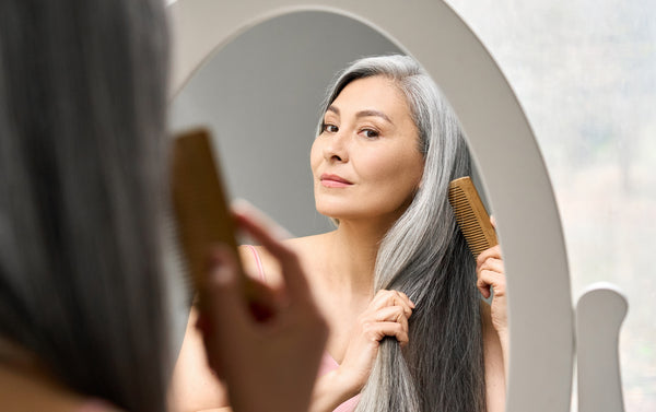 Woman Brushes her Lovely Grey Hair