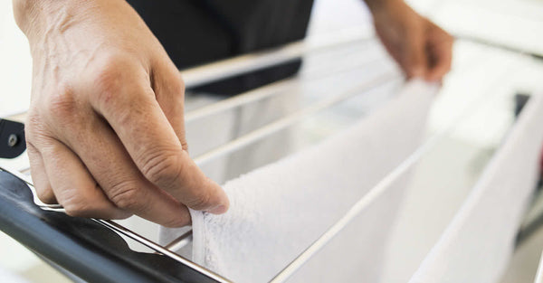 Man hanging a silk pillowcase on a drying rack