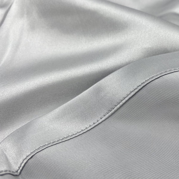Silk Charmeuse weave showing a smooth luster on one side of the fabric and a matte finish on the reverse