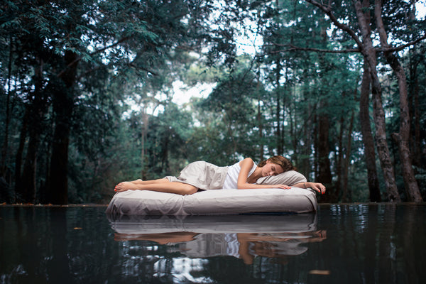 Woman Sleeping on a Raft in the Middle of the Water