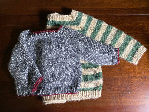 Flat Lay of two small child Flax Sweaters