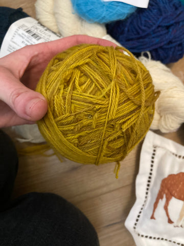 Yellow skein of yarn with moth evidence