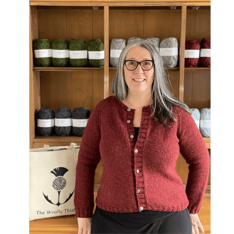 Corinne wears her red Victory Cardigan