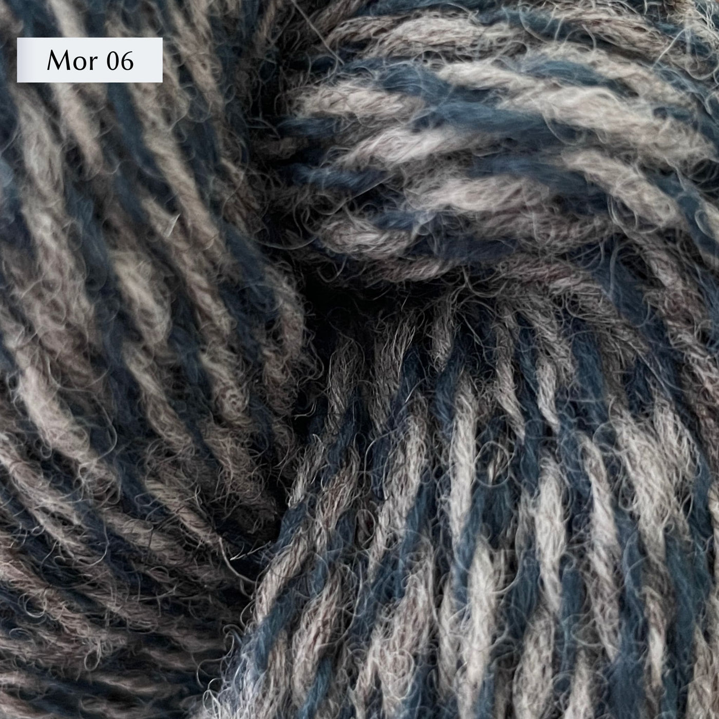Garthenor Teifi, a sport weight marled yarn, in color Mor 06, a marl of heathered grey and a dark denim blue