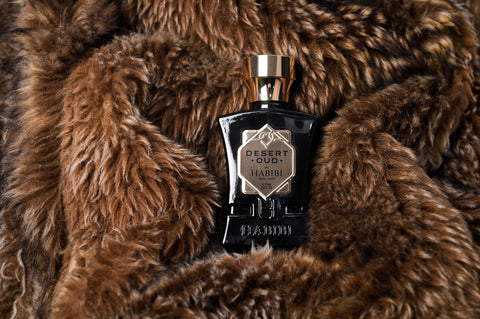 Desert Oud bottle laying on a brown fur coat