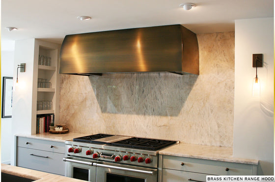 Brass custom made range hood with brushed features. 