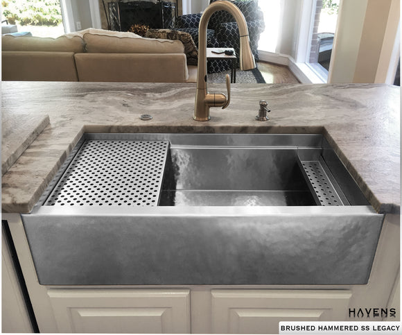 Brushed hammered custom stainless sink with a farmhouse apron front and built in ledge.