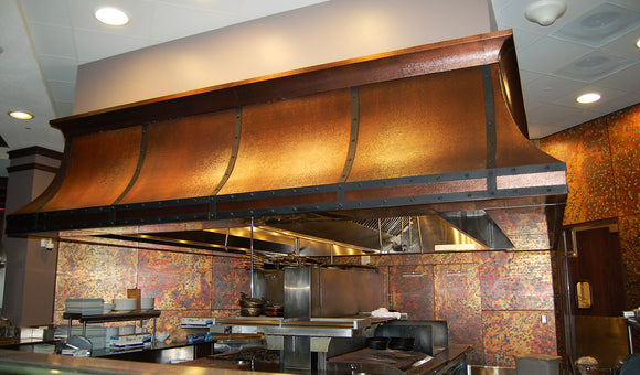 Hammered copper range hood built by Havens Metal for a commercial kitchen in Orlando, FL.