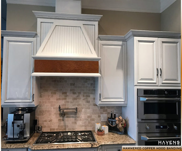 Custom hammered copper kitchen range hood band.