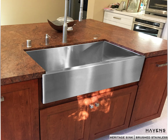 Stainless steel farmhouse apron front sink installed as an undermount single bowl.