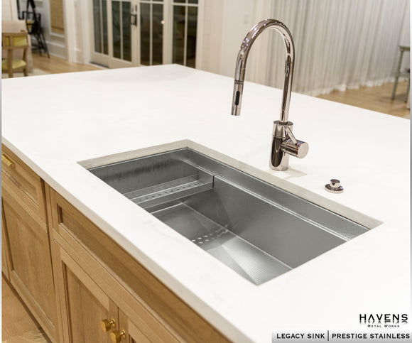 Custom stainless steel Legacy undermount kitchen sink with a built-in workstation ledge.