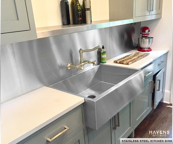 Kitchen with stainless steel topmount sink. Custom depth and farmhouse apron front.