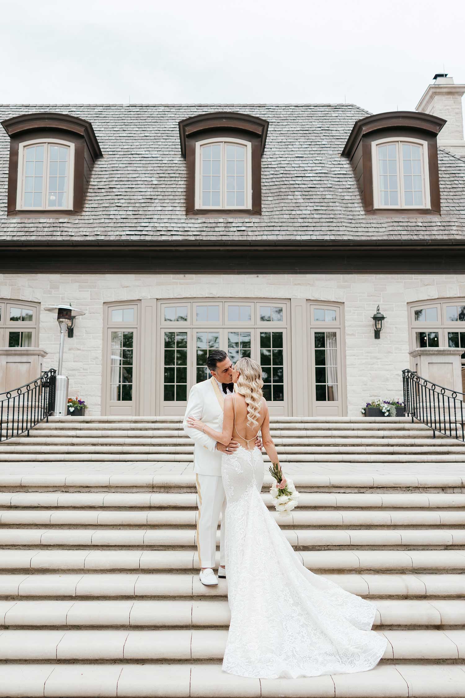Bride and groomed photographed posing on steps