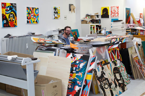 Roman Klonek at work in his art studio surrounded by paintings