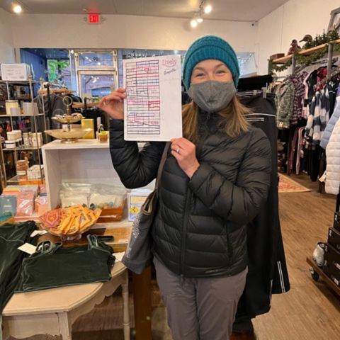 female runner in cold weather apparel holding a map of oak park