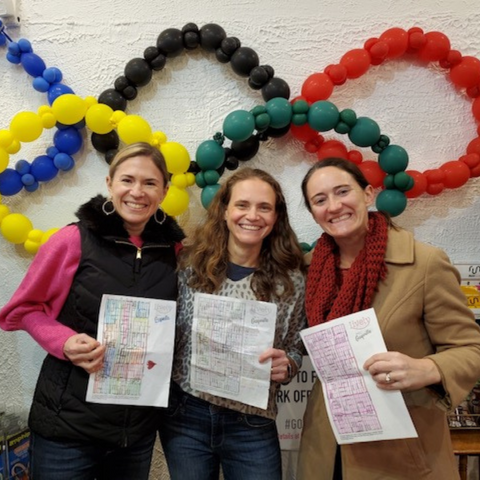 3 female runners smiling and holding maps of oak park