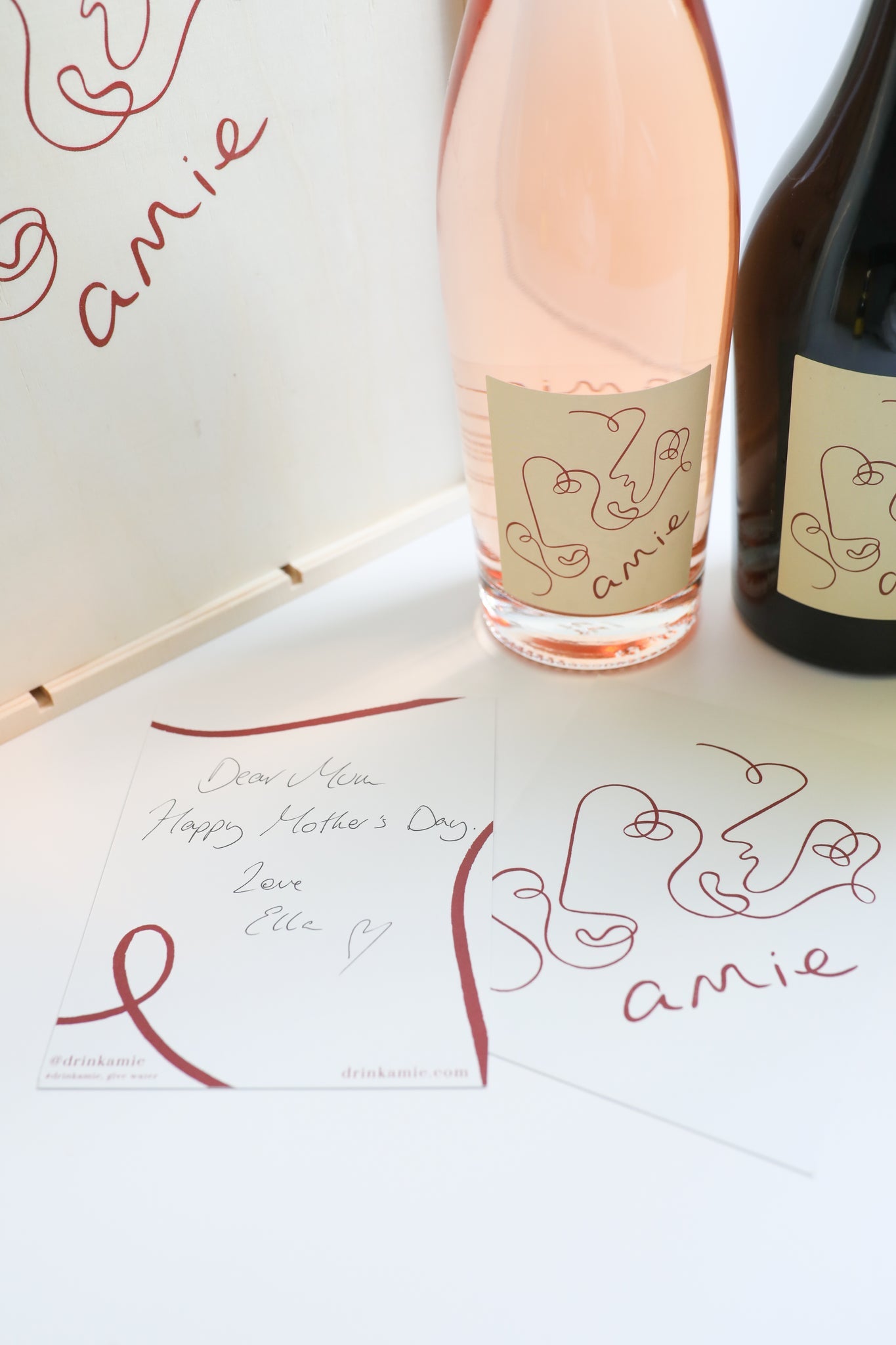 a Amie wine gift set of stylishly labeled red and rose wines in a wooden box, with a mother's day gift note