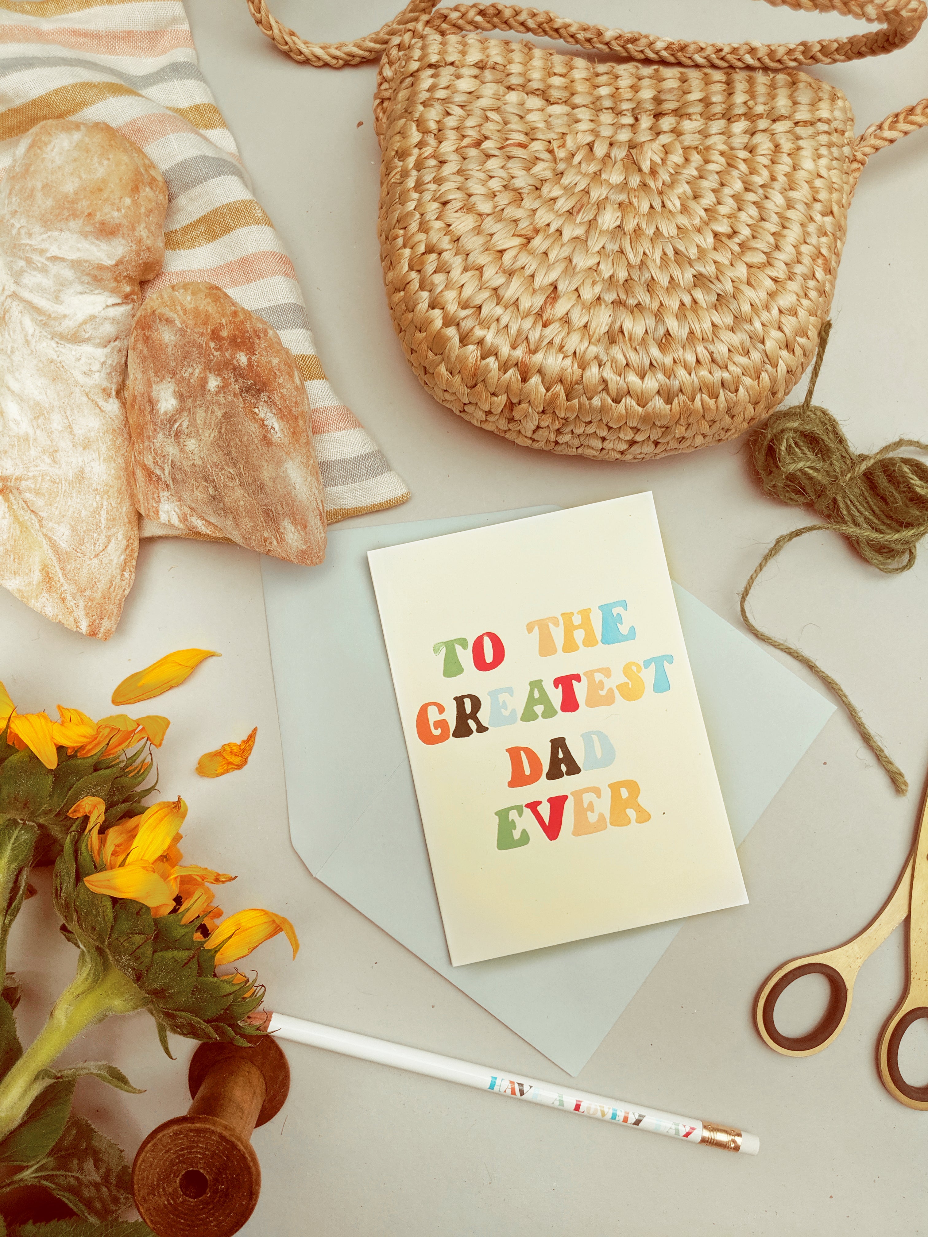 father's day card surrounded by freshly grown produce, a cuppa and some sunflowers