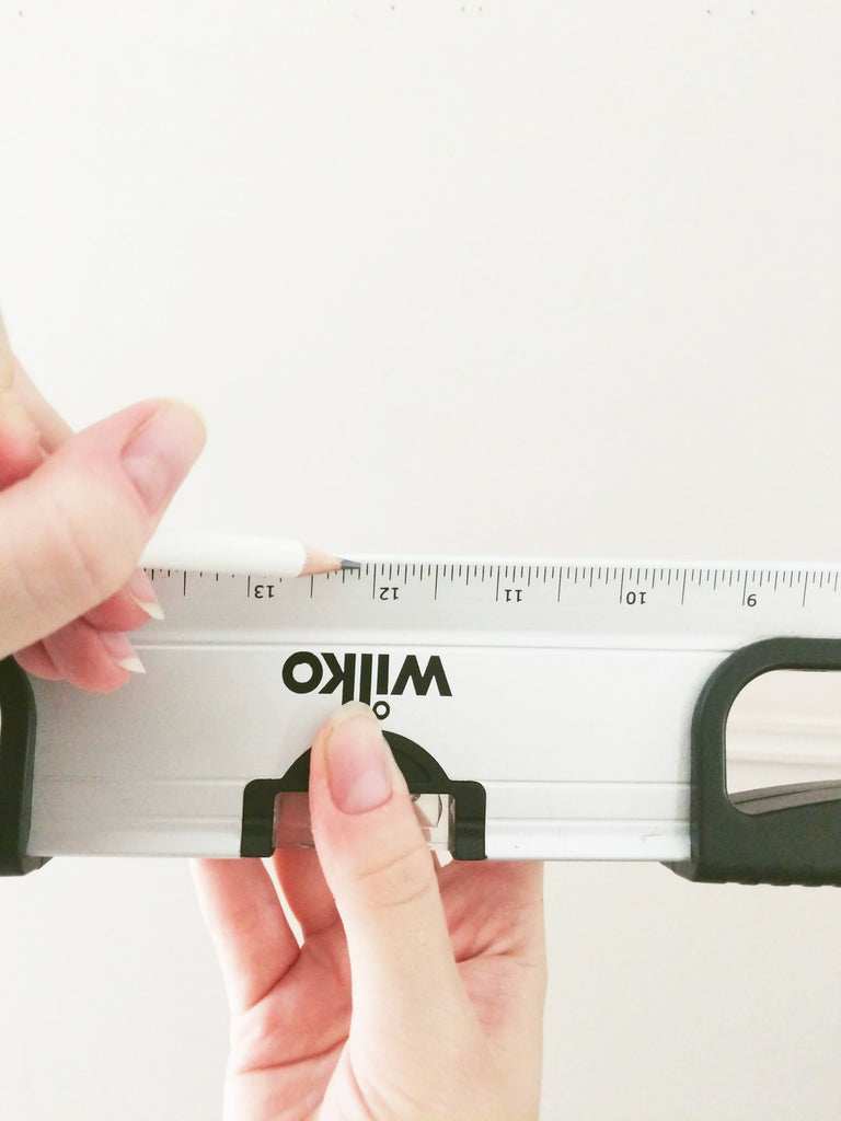 marking a pencil mark on a spirit level