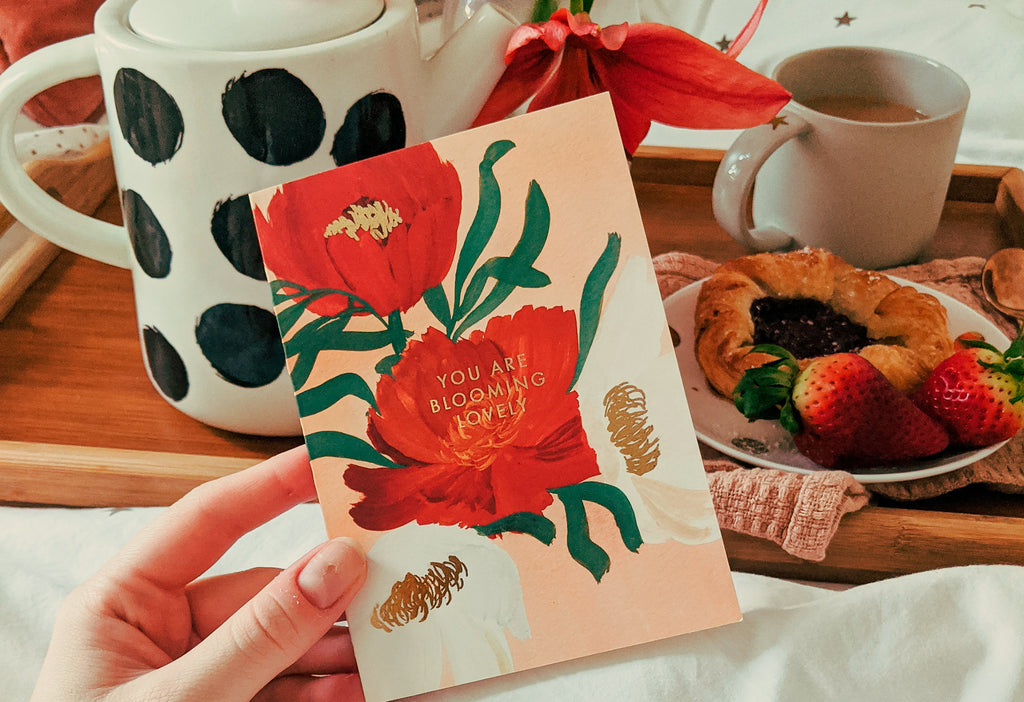 a valentines card with a floral design reads "you're blooming lovely"